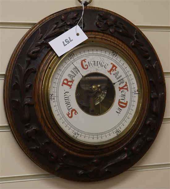 A Victorian carved oak aneroid barometer W.36cm
